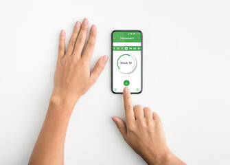 Young pregnant woman using mobile application for pregnancy