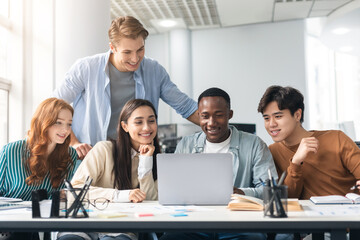 Group of international people using laptop at classroom
