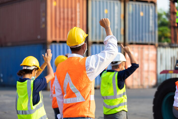 Strike of workers in container yard. Group of multiethnic engineer people during a protest in workplace