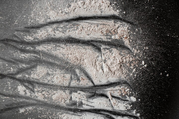 white powder on black background, flour sprinkled