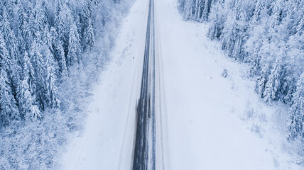 Natural background. View from the height of the winter forest and the road.