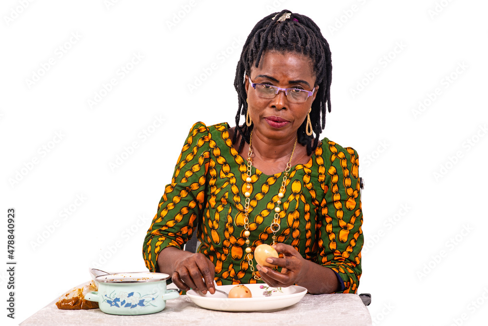 Wall mural beautiful adult housewife preparing breakfast with eggs.