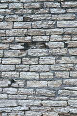 old stone wall made of weathered bricks as background