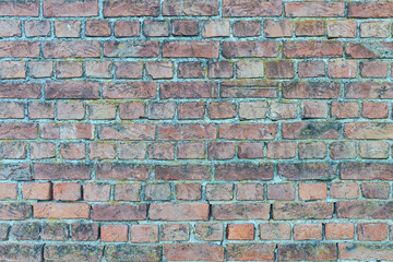 old stone wall made of weathered bricks as background