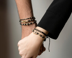 Hand in hand two lovers and unisex bracelets
