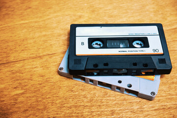 Two vintage audio cassettes lie on the table