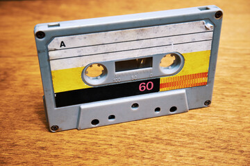 Vintage audio cassette on wooden table close up