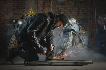 Man in the leather jacket works in the motorbike workshop concept.