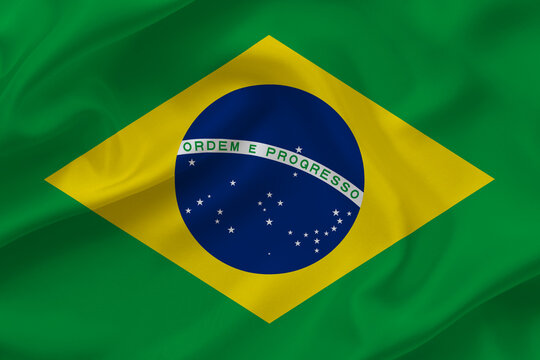 Brasil flag on waving silk background. Fabric texture.