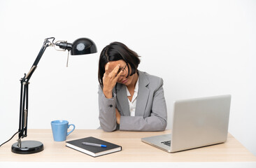 Young business mixed race woman working at office with headache