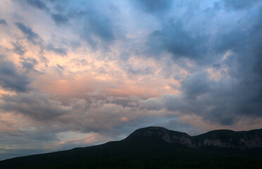 Beautiful clouds over mountains in the evening sky