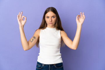 Young Lithuanian woman isolated on purple background in zen pose