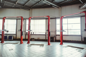 car lift in car service with soft focus, car maintenance