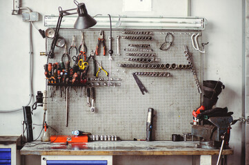 Locksmith's table with keys and tools for the repair of mechanical equipment. Car workshop