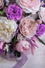 Beautiful spring Flowers in bouquet in pink and purpl color. Arrangement with Peonies roses. Flowers decor.