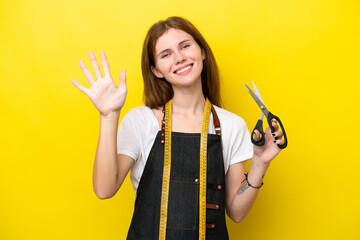 Young seamstress English woman isolated on yellow background counting five with fingers