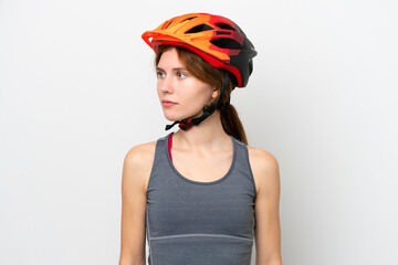 Young cyclist English woman isolated on white background looking to the side