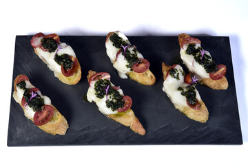 bruschetta bread with pesto cheese and tomatoes