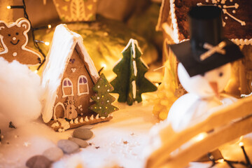 Gingerbread house with glaze on snow and decorations. Christmas holiday mood.