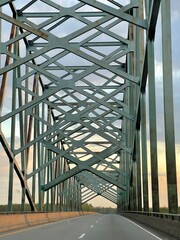 Green lattice bridge at sunset