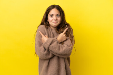 Little caucasian girl isolated on yellow background pointing to the laterals having doubts