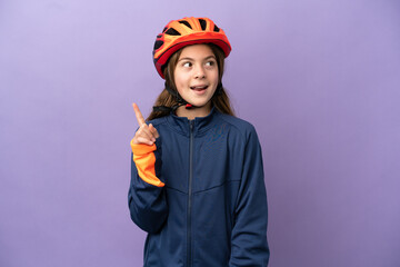 Little caucasian girl isolated on purple background thinking an idea pointing the finger up