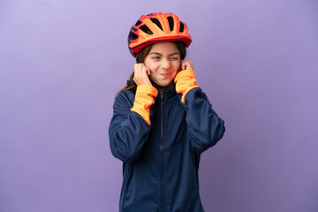Little caucasian girl isolated on purple background frustrated and covering ears