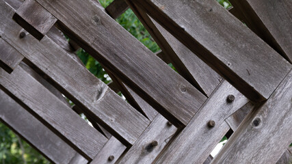 Abstract: Weathered Wooden Beams forming a Geometric Pattern