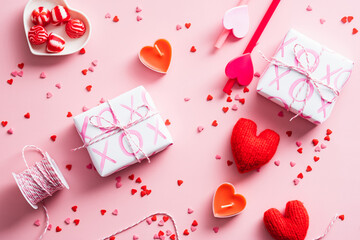 Happy Valentines Day concept. Flat lay composition with gift boxes, red hearts, ribbon, sweets on pink table.