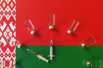 Syringes and medical vials on the flag of Belarus. Vaccination related conceptual 3D rendering