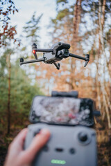 Flying drone in countryside in forest