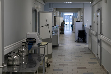The hospital corridor of a Russian hospital. The doors to the wards are open, with a nurse's...