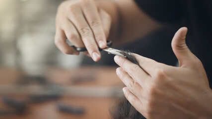 Man with scissors while cutting hair