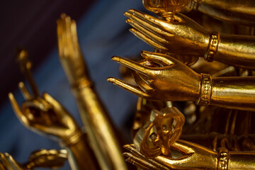 Gold hands of image buddha in buddhist temple
