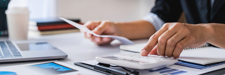 Close-up calculator  to calculate the company's financial results On the wooden table in the office...