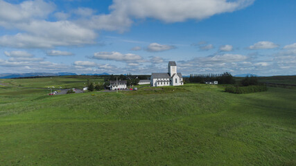 Magnificent Lutheran church or cathedral in Skalholt area of Iceland on a warm summer day.  Majestic church in the middle of green fields and plains. - obrazy, fototapety, plakaty