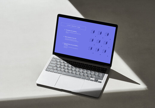 Silver Laptop on a Grey Surface with Hard Shadows