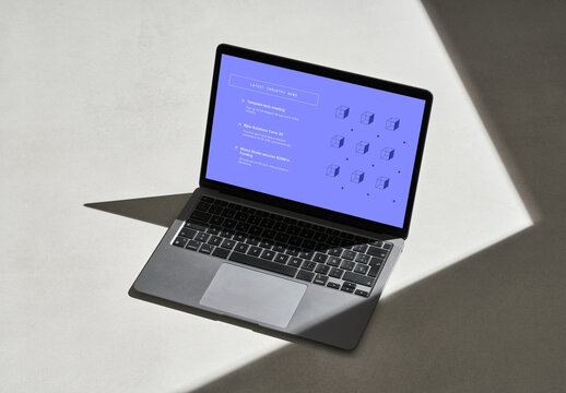 Silver Laptop on a Concrete Surface with Shadows