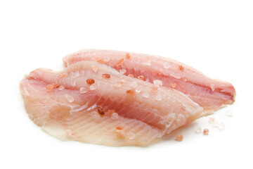 Prepared raw white fish fillet sprinkled with pink salt