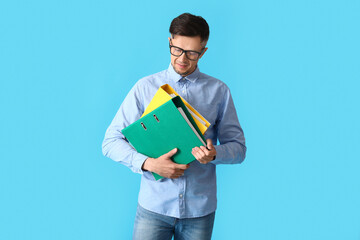 Man with folders on color background