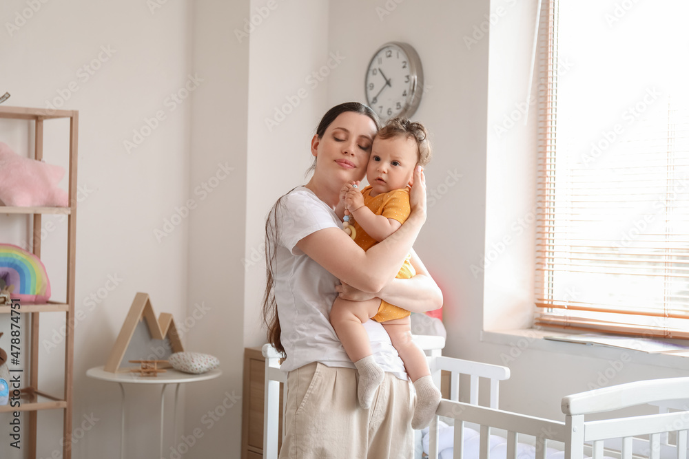 Canvas Prints young mother holding her little baby in bedroom