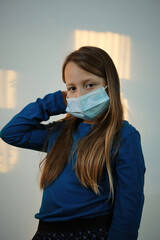 a girl posing with medical mask on the face