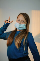 a girl posing with medical mask on the face