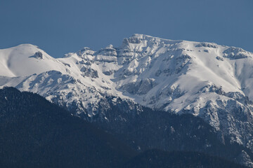 Fototapeta premium Bucegi Mountains seen from the city of Bran, Romania. Beautiful winter landscape. Part of the Carpathians Mountain Range.
