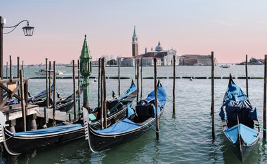 Fototapeta na wymiar gondolas moored to the Grand Canal, in the background Santa Maria della Salute basilica.Venice, Italy
