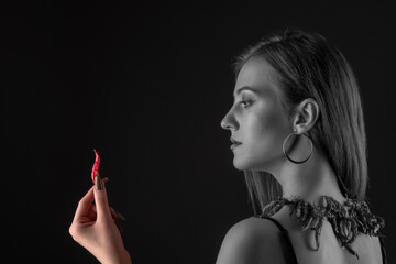 Obraz premium Beautiful Young Smiling Woman Holding Red Hot Chili Pepper.