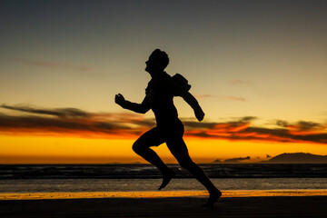 Fototapeta na wymiar Running on the beach jogging exercise active sprinting selective focus beach background