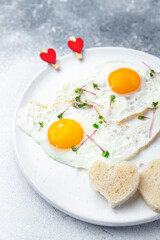 valentines day breakfast on the table scrambled eggs heart shape holiday decoration love date copy space food background