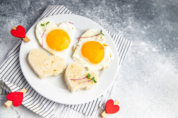 valentines day breakfast on the table scrambled eggs heart shape holiday decoration love date copy space food background