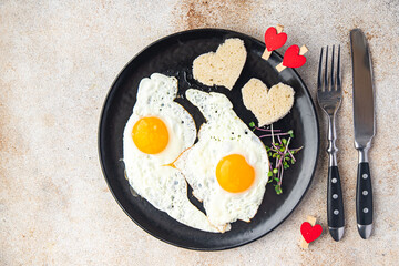 valentines day breakfast on the table scrambled eggs heart shape holiday decoration love date copy space food background